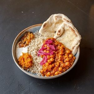 Chana Masala with soy yoghurt, carrot-orange chutney, mango chutney and pickled onions at Wildflower Canteen in Leiden