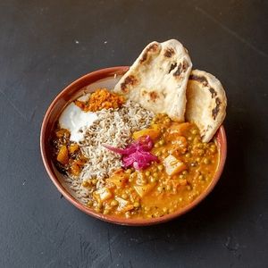 Aloo Matar with soy yoghurt, carrot-orange chutney, mango chutney and pickled onions at Wildflower Canteen in Leiden