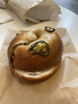 Jalapeño bagel with bacon scallion smear  at Ben & Esther's Vegan Jewish Deli in Seattle