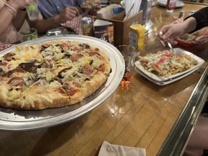 Vegan sausage pizza and vegan chili fries  at Bunzy's & Booze in Colorado Springs