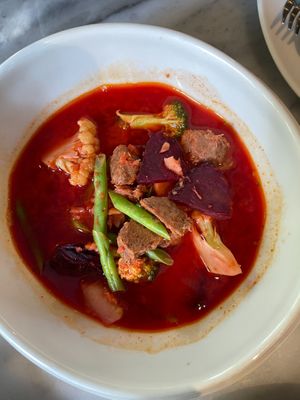 Thai Sour Mixed Vegetable and Gac Juice Soup 160 thb
 at Tonklar Facai - Mahidol Salaya in Nakhon Pathom