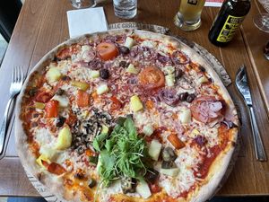 Vegan half-and-half pizza with added pineapples  at L'Osteria in Hannover