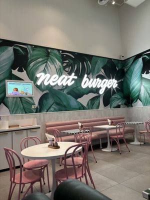Clean, bright & adorable pink tables  at Neat Burger - Dubai Mall in Dubai