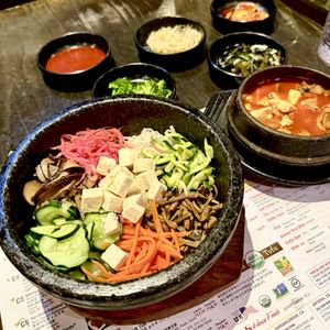 Hot Stone Vegetable Bibimbap and Mushroom Soon Tofu Soup (these dishes are typically served with egg, say no egg; ask for water for the soup instead of beef broth)  at BCD Tofu House in New York City