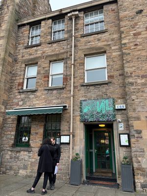 Street view of exterior with a couple waiting to see if they can get a table as a walk in OR waiting due to being early... at Soul Vegan in Edinburgh