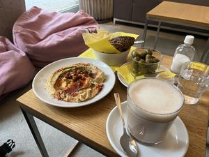 Hummus, marinated olives and (oat milk) chai latte  at Nude Zurich in Zurich