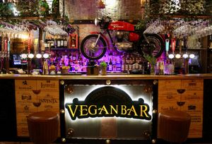 Bar counter with Royal Enfield mounted on the wall. at Donald Watson's Vegan Bar in Leicester