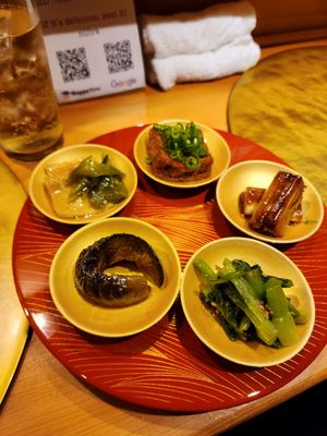 Bunch of small plates of the most incredible bites of our trip at Vegan Izakaya NIJIYA 虹屋 in Kyoto