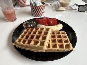 Vegan waffle with strawberry, banana, and maple syrup. Strawberry juice on the side.  at Bowl Acai Bar in Puerto Ayora