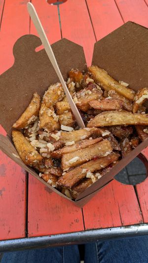 Chips with garlic and rosemary seasoning, sweet chilli sauce and cheese. at The Hippy Chippy in Bristol
