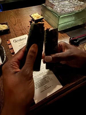 Fancy mini sushi burrito for one of the courses   at Omakaseed in New York City