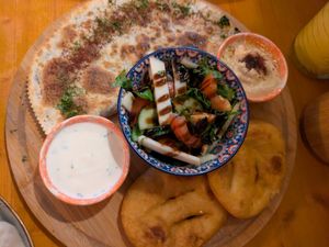 Qutab (flatbread filled with spinach), salad, yoghurt sauce, hummus, and fried breads at Dervish in Berlin