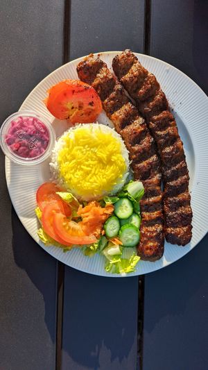 Plant based koobide kebab / with half salad half rice, red cabbage pickles and grilled tomatoe at Celeshmet in Vancouver