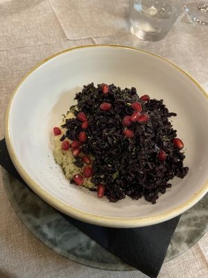 Riso venere con crema di melanzana e menta e melograno  at Contorni e Dintorni in Rivoli