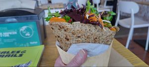 The technique for eating it is written on the wall! You really need to squash it as flat as you can. at Mano Wraps in Busselton