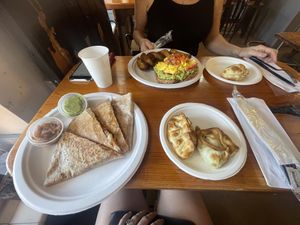 Vegan jackfruit quesadilla (bottom left), vegan spinach empanada & vegan corn empanada (bottom right), vegetarian spinach empanada (up right), vegetarian avocado toast (up left)  at Dark & Light Cafe in Mount Dora