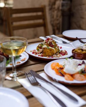 Spiced roast cauliflower with roasted almonds, orange mayo and pomegranate (Vegan & GF) at Idle Hands in Girona