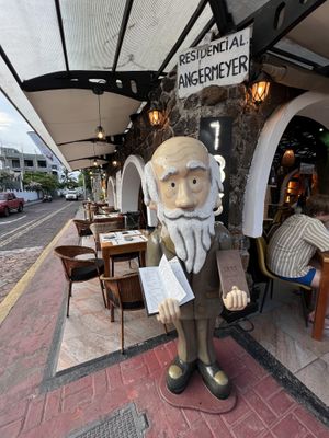 Darwin holding the Menu    at 1835 Coffee Lab in Puerto Ayora