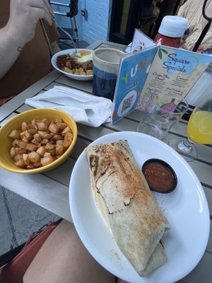 Vegan burrito and side of potatoes. Vegetarian option in the background    at Square Cafe in Pittsburgh