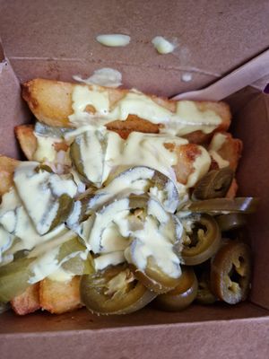 Cheesy pickle topped chunky chips. at Falafia in Beverley