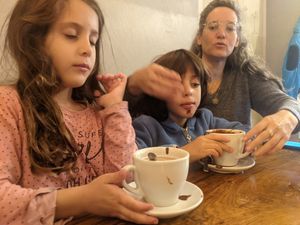 Enjoying hot vegan chocolate with cream at Hug the Mug in Sibiu