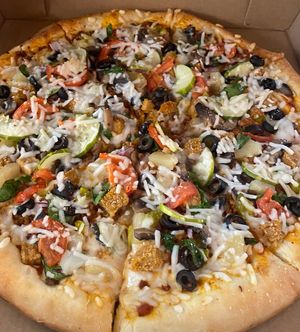 Freshly prepared and homemade supreme veggie and vegan meat pizza! Absolutely a must have!  at Lily's Herbs & More in Indialantic