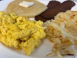 Weekend Breakfast Special! Pancake served with organic maple syrup, vegan eggs, hashbrowns and vegan bacon! So delicious. We have gluten free option for the pancake as well!!! at Lily's Herbs & More in Indialantic