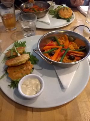 Vegan paella bake served with deep fried mixed vegetable tortillitas and a roasted garlic vegan mayo at Sky Apple Cafe in Newcastle Upon Tyne