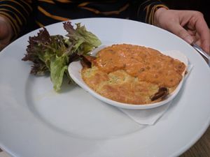 Souffle Pancake [£10.50] – Garlicky spinach, red onion marmalade, Camembert & Stilton cheese wrapped in crepe with chervil and dill souffle topped with lentil, tomato, ginger sa at Sky Apple Cafe in Newcastle Upon Tyne