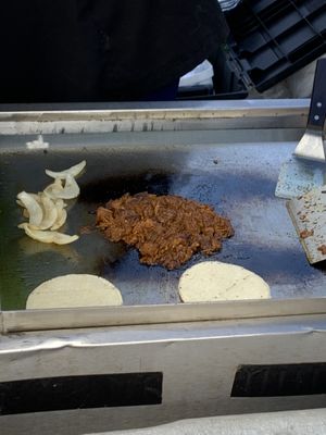 Jackfruit tacos and grilled onions being prepared   at hippiestacos in Long Beach