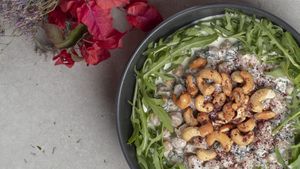 From the Levantine countryside, a spiced chickpea and spinach mix bathed in a citrusy yogurt and tahini sauce, crowned with toasted cashews and fresh arugula at La Escala in Tenerife