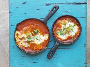 Poached egg topping a tomato and miso stew, with eggplant and mixed peppers. Served with a side of homemade focaccia at La Escala in Tenerife