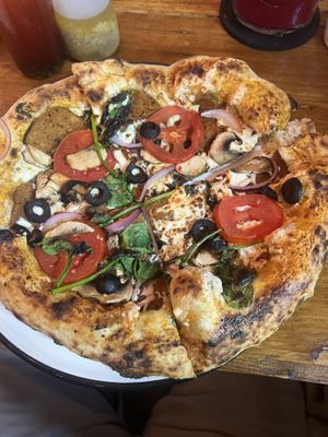 Can’t remember the name but I added pepperoni, onions, and tomatoes.  Had a little spice to it  at Pizzeria Distrito Vegano in Merida