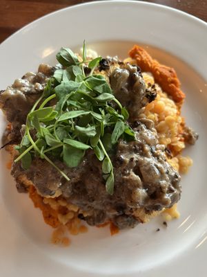 Presentation was beautiful. It’s carrot purée on the bottom, yellow split peas, cauliflower with mushroom gravy   at Main Deck in Penn Yan
