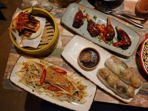 NOT Chicken Steamed Bao Bun, NOT Hot Sweetie Wings, Goi Mango Salad, and Tofu & Mushroom Summer Rolls. at Vietnamese Street Kitchen in Birmingham