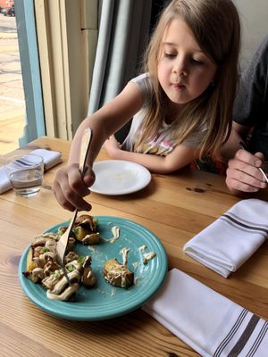 Roasted potatoes with nacho cheese and chives at Cafe Gratitude in Kansas City