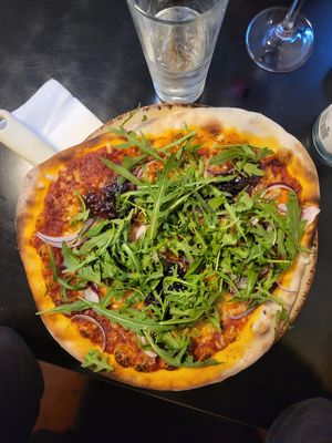 Pizza with tomato and chilli base ! Onion grilled and fresh one, whit rocket at Little Wing in Holywood