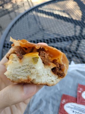 Last bite of kolache full of sausages, cheese, and jalapeños at Capital City Bakery in Austin