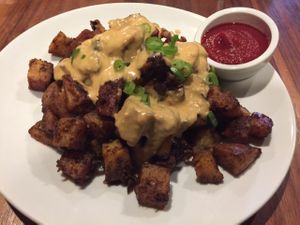 Patatas Bravas (roasted red potatoes, cashew cheese and scallions) at Real Food Daily - Pasadena in Pasadena