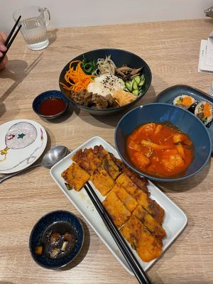 Beef bibimbap, spicy rice cake, half eaten kimbap, kimchi pancake at MukBap in London