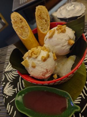 Coconut ice cream with peanuts, banana spring roll, sticky rice and sauce at Noodles Now in Koh Samui