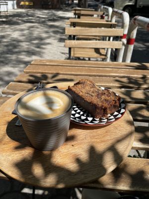 Oatmilk cappuccino and delicious vegan bananabread  at Hana Corner Cafe in Tirana
