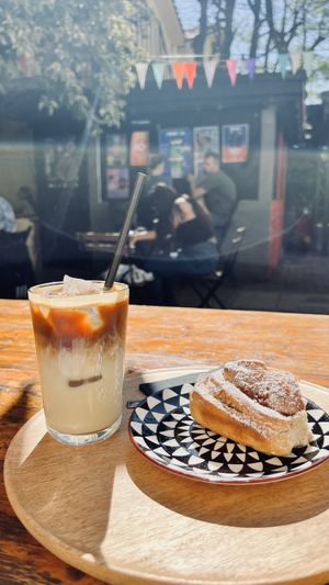 Oat milk latte & vegan cinnamon roll   at Hana Corner Cafe in Tirana
