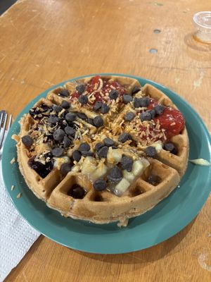 Vegan waffle with fruit toppings, toasted coconut, vegan custard, and vegan chocolate chips  at The Waffle Lady in St Johns