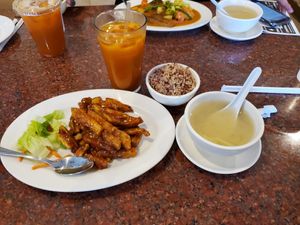 Crispy spicy eggplant, Thai ice tea. Curry fish with potato in the back ground at Veggie House in Las Vegas