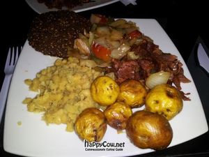 Lunch plate at Vital with yellow lentils, yellow potatoes, fake ham, and falafel. at Vital in Santa Marta