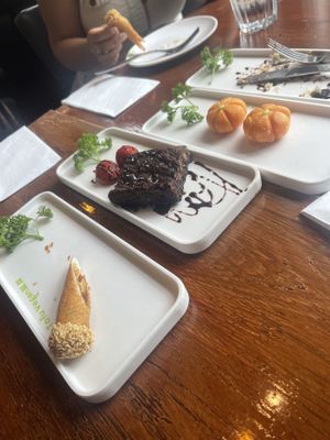 (Left-right) sesame rolls stuffed with red bean paste, vegan brownie, pumpkin lantern (pumpkin rice ball stuffed with lotus seed paste)  at Tofu Vegan - Spitalfields in East London