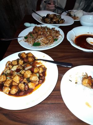 Gong bao tofu (front left) sticky and sweet. Special noodles (behind) generous portion and delicious at Tofu Vegan - Spitalfields in East London