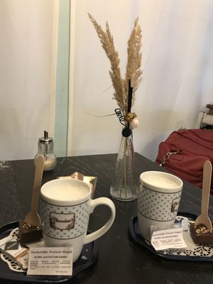 Hot chocolate stirrers and a mug of hot oat milk  at Café Allerlei in Trier