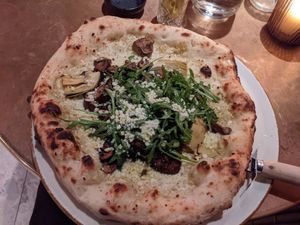 Pizza with truffle oil, mushrooms, artichoke, and rocket at Vegitalian Pizza Bar in Utrecht